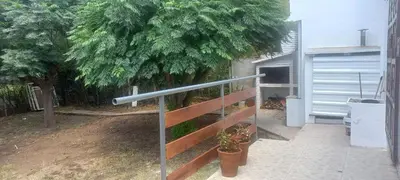 a view of a fence with a tree and a garage at La Delia in Villa Cura Brochero