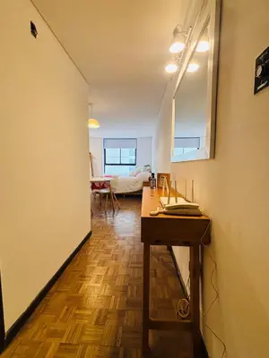 a room with a table and a mirror on the wall at Hermoso Apartamento en Edificio Saint Michel in Cordoba