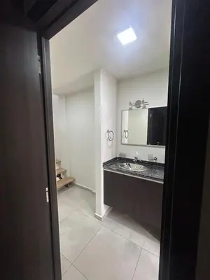 a bathroom with a sink and a mirror at Miralejos Apart Triplex in Villa Carlos Paz