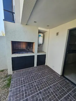 a fireplace on the side of a building at Miralejos Apart Triplex in Villa Carlos Paz
