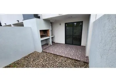 a door to a building with a cat sitting on the ground at Miralejos Apart Triplex in Villa Carlos Paz