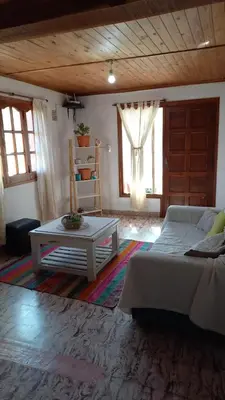 a bedroom with a bed and a coffee table at CASA ANTONIA in Embalse