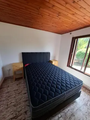 a large bed in a room with a wooden ceiling at CASA ANTONIA in Embalse