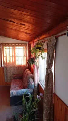 a couch in the corner of a room with windows at El Vergel in Santa María