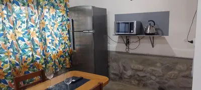 a room with a table and a tv on a wall at El Vergel in Santa María