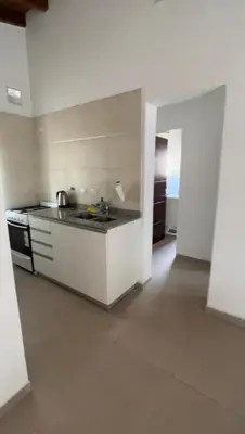 a white kitchen with a stove and a sink at Villa Simona in Santa Rosa de Calamuchita