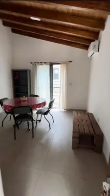 a living room with a table and chairs and a couch at Villa Simona in Santa Rosa de Calamuchita