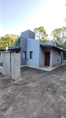 a large white house with a driveway in front of it at Villa Simona in Santa Rosa de Calamuchita