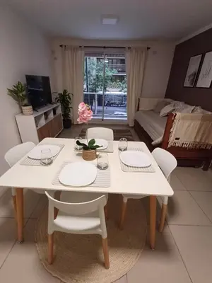 a white table and chairs in a living room at Hermoso departamento doble be in Cordoba