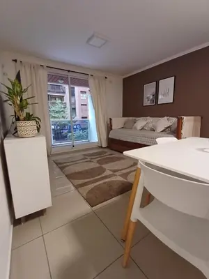 a living room with a bed and a window at Hermoso departamento doble be in Cordoba