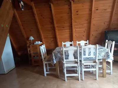 a dining room with a table and four chairs at Alpinas La Linda in Villa General Belgrano