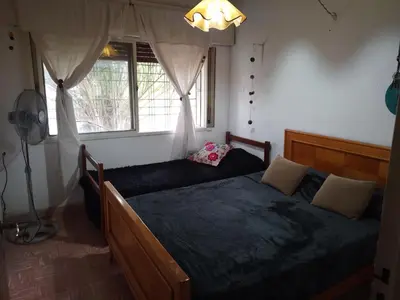 a bedroom with a large bed and a window at Alquiler temporario villa Carlos Paz in Villa Carlos Paz
