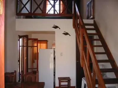 a room with a staircase and a refrigerator at Cabañas Oma Lissi in Merlo