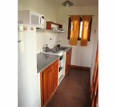 a small kitchen with a sink and a microwave at Cabañas Oma Lissi in Merlo