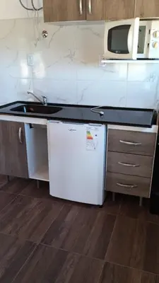 a kitchen with a sink and a microwave at Portezuelo de árboles in Panaholma