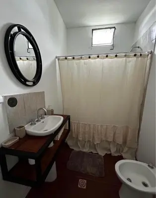 a bathroom with a sink and a toilet and a mirror at Departamentos MarCor in Nono