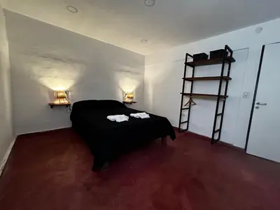 a bedroom with a bed and a ladder in a room at Departamentos MarCor in Nono