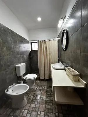 a bathroom with a toilet and a sink at Departamentos MarCor in Nono