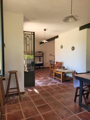 a room with a tiled floor with a table and chairs at Casona y Casa de Campo in Santa María