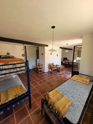 a bedroom with two bunk beds and a living room at Casona y Casa de Campo in Santa María