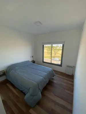 a bedroom with a bed in a room with a window at Dalcar Apart in Río Cuarto