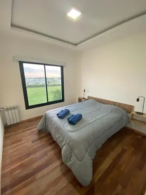 a large bed in a room with a large window at Dalcar Apart in Río Cuarto