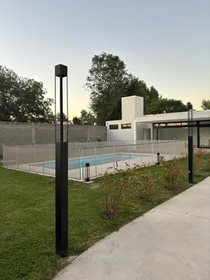 a pole in the grass in front of a building at Dalcar Apart in Río Cuarto
