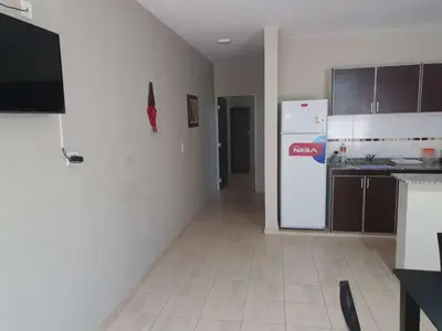 a kitchen with a white refrigerator and a white tile floor at HERMOSO DEPARTAMENTO EN QUINES in Quines
