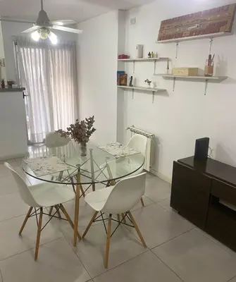 a dining room with a glass table and chairs at Departamento -Torre Duomo- a 50mts de la Terminal de Ómnibus de lado de Barrio Nueva Cordoba, By Apartcba in Cordoba
