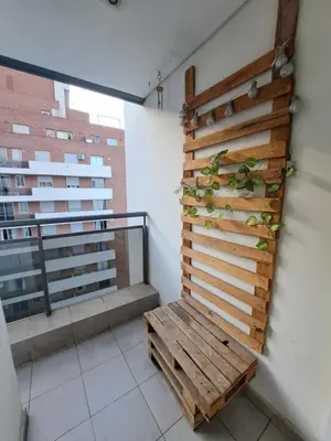 a wooden bench in a room with a balcony at Departamento -Torre Duomo- a 50mts de la Terminal de Ómnibus de lado de Barrio Nueva Cordoba, By Apartcba in Cordoba
