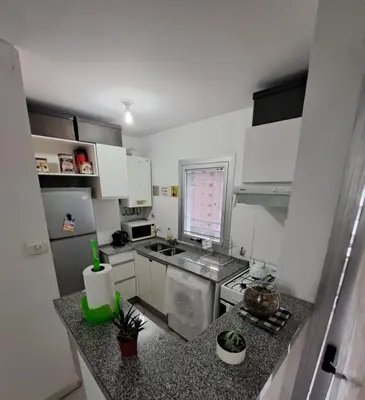 a small kitchen with white cabinets and a counter top at Departamento -Torre Duomo- a 50mts de la Terminal de Ómnibus de lado de Barrio Nueva Cordoba, By Apartcba in Cordoba