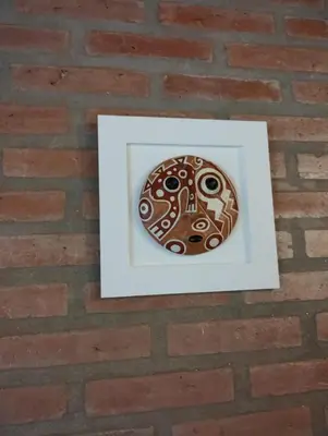a button in a picture frame on a brick wall at Alberobello Casa Serrana in Santa Rosa de Calamuchita