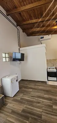 an empty room with a refrigerator and a stove at LitStay Monoambiente in Cordoba