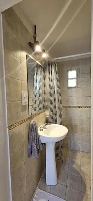 a bathroom with a white sink and a mirror at LitStay Monoambiente in Cordoba