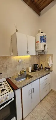 a kitchen with a sink and a microwave at LitStay Monoambiente in Cordoba