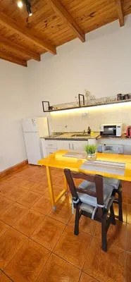 a yellow table and chairs in a kitchen at LitStay Monoambiente in Cordoba
