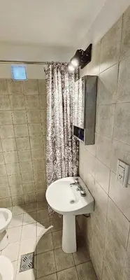 a bathroom with a sink and a shower curtain at LitStay Monoambiente in Cordoba