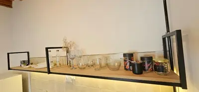 a shelf with many glass jars on a wall at LitStay Monoambiente in Cordoba