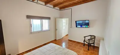 a room with a bed and a television on the wall at LitStay Monoambiente in Cordoba
