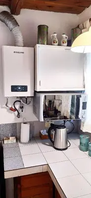 a kitchen counter with a coffee pot and a microwave at Departamento San Antonio in San Antonio de Arredondo