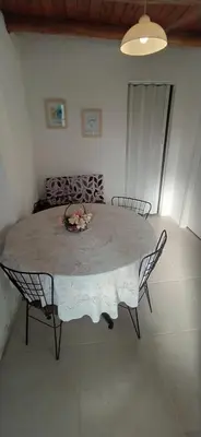 a table and chairs in a room with a table and a table and chairs at Departamento San Antonio in San Antonio de Arredondo