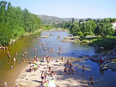 a group of people on a beach in a river at Departamento San Antonio in San Antonio de Arredondo