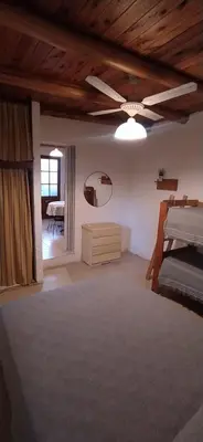 a bedroom with a ceiling fan and a bed at Departamento San Antonio in San Antonio de Arredondo