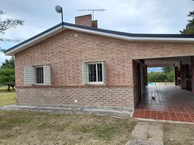 a brick house with an open garage at Casa en Potrero de Garay in Potrero de Garay