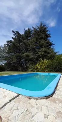 a blue swimming pool sitting on top of a stone ground at Casa en Potrero de Garay in Potrero de Garay
