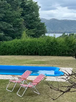 two lawn chairs sitting next to a swimming pool at Casa en Potrero de Garay in Potrero de Garay