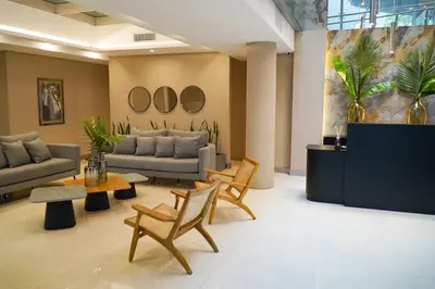 a living room with couches and a table and chairs at Amérian Río Cuarto in Río Cuarto