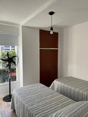 a bedroom with two beds and a window at Departamento Pleno Centro de Córdoba Capital in Cordoba