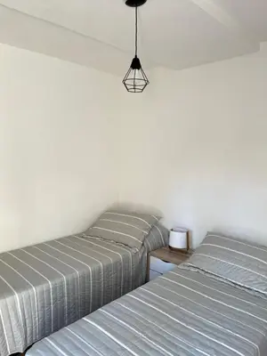 two beds sitting next to each other in a bedroom at Departamento Pleno Centro de Córdoba Capital in Cordoba