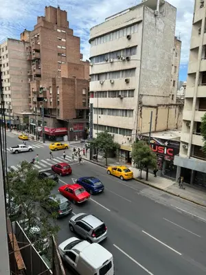 a busy city street filled with cars and buildings at Departamento Pleno Centro de Córdoba Capital in Cordoba